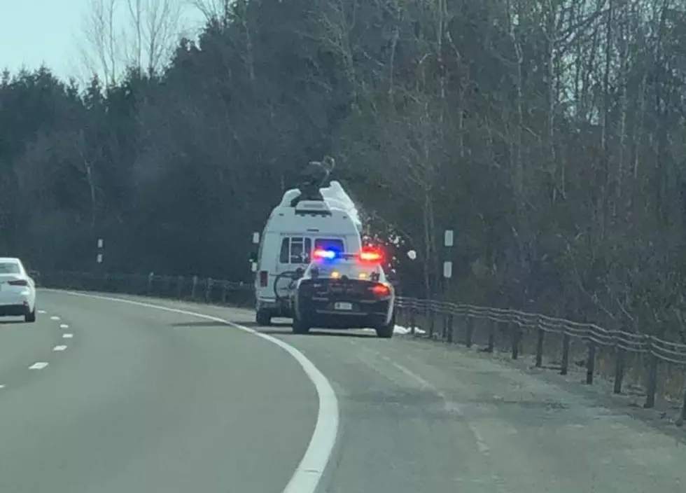 New York State Police Trooper Clears Snow From Van Roof Off I-81